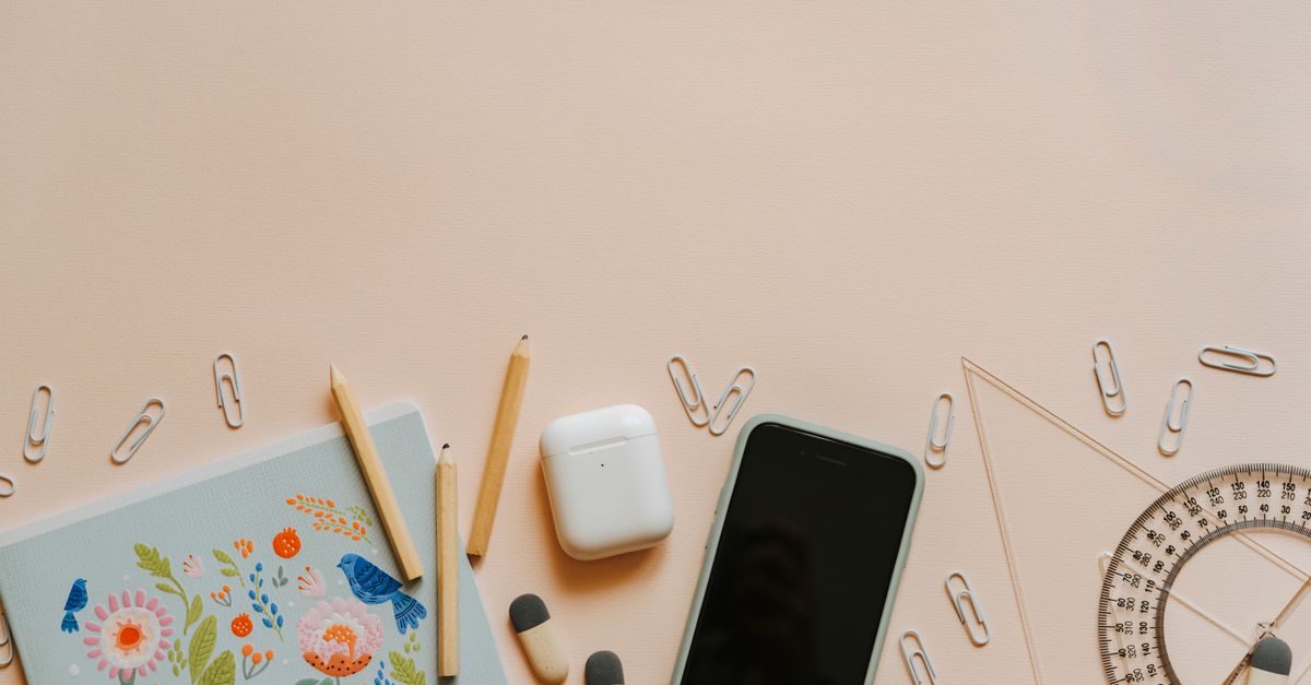 A top-down view of school supplies and tech gadgets on a desk, ideal for education themes.