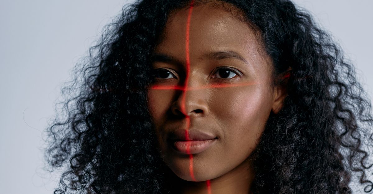 A futuristic portrait of a woman with laser scanning lines on her face, representing advanced technology.