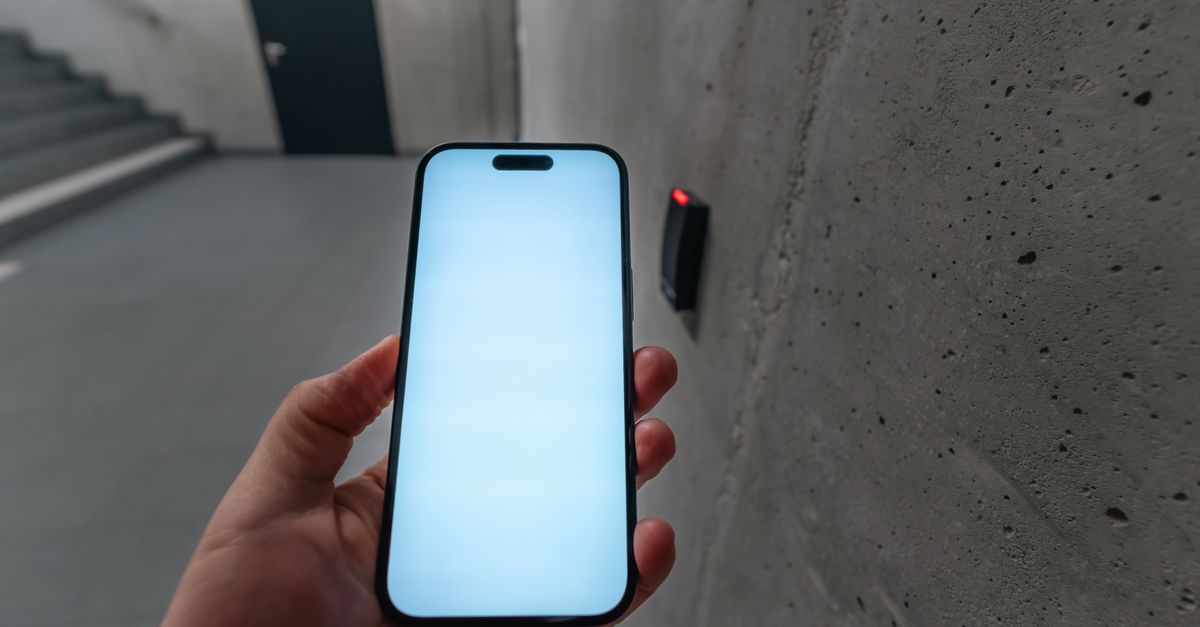 A smartphone unlocking a secure door using NFC technology in a modern building stairwell.
