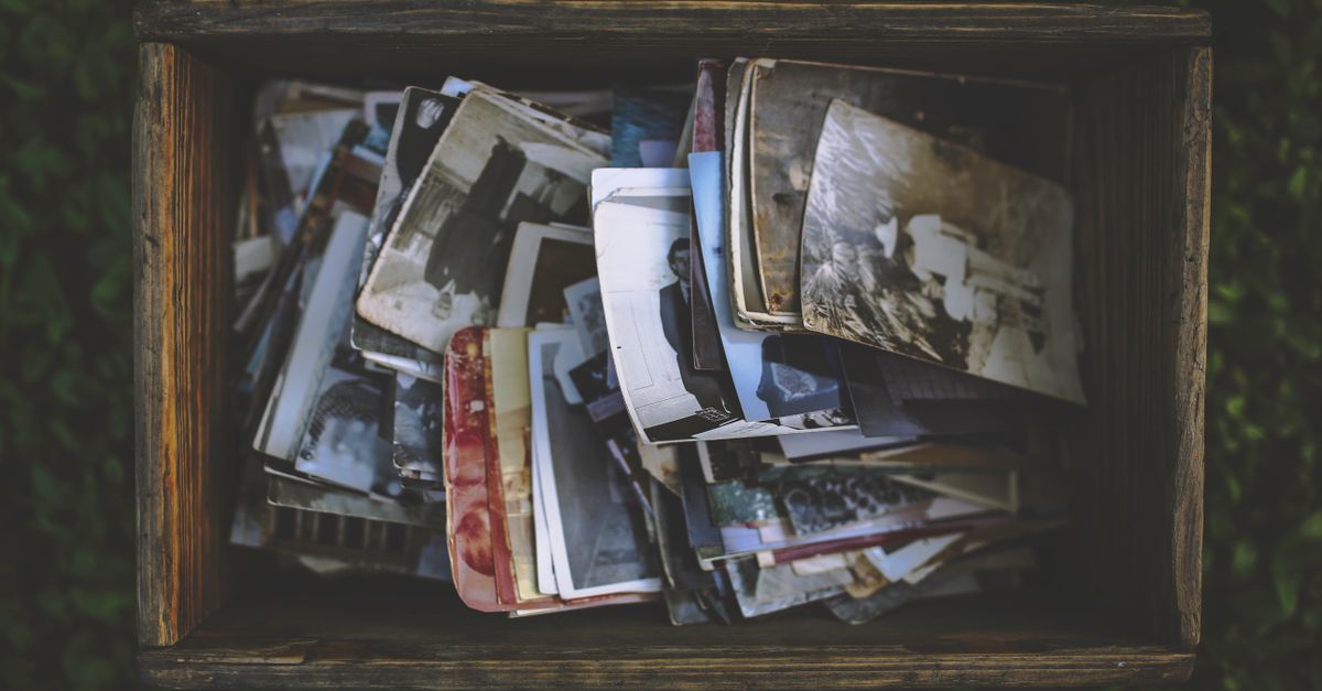 A nostalgic collection of vintage photos in an old wooden box.