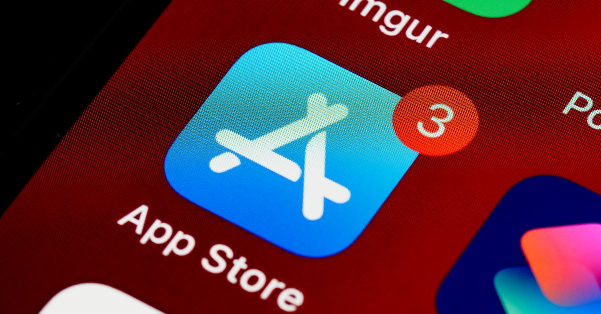 Close-up of App Store icon on iPhone screen with notification badge, highlighting app updates.