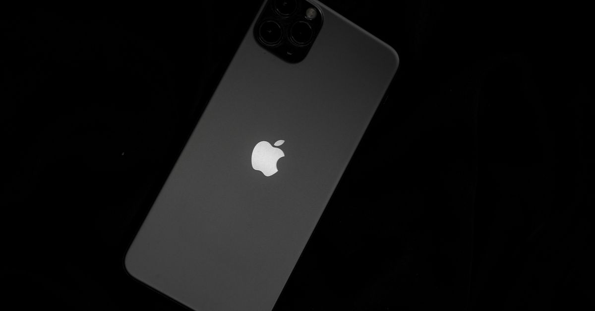 Close-up of a sleek smartphone featuring the iconic Apple logo against a black background.