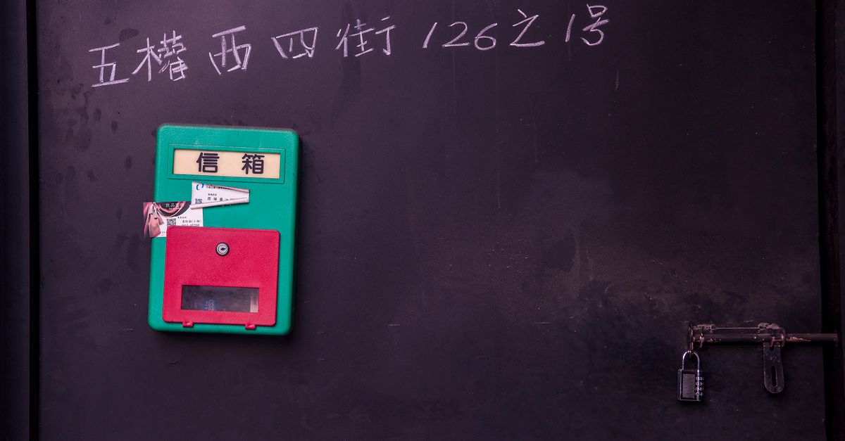 Colorful mailbox attached to a black wall, featuring a retro padlock in Taichung.