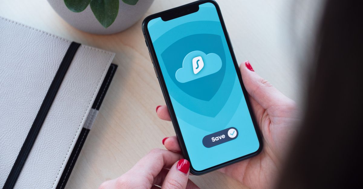 Woman using a secure mobile app, showcasing data encryption on a smartphone.